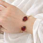 Luxury 18K Gold Open Cuff Bracelet with Red Gemstones.