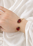 Luxury 18K Gold Open Cuff Bracelet with Red Gemstones.