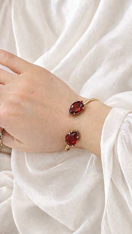 Luxury 18K Gold Open Cuff Bracelet with Red Gemstones.