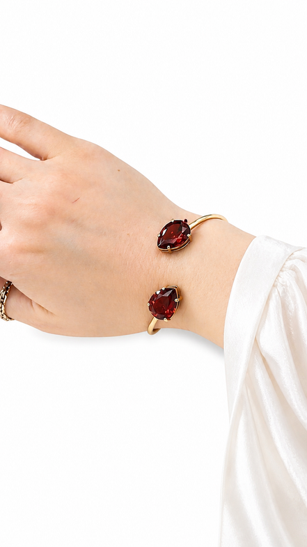 Luxury 18K Gold Open Cuff Bracelet with Red Gemstones.